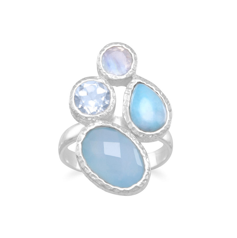 Textured sterling silver multishape stone ring. The faceted oval blue chalcedony is approximately 8mm x 12mm, the pear shape larimar is 6mm x 9mm, the blue topaz is 6mm and the rainbow moonstone is 4mm. The band is approximately 3mm. .925 Sterling Silver