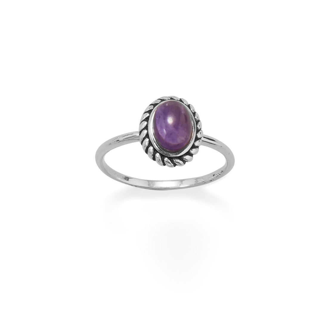 Indulge in opulence with this exquisite sterling silver ring. Meticulously crafted, it showcases an alluring oval amethyst stone, elegantly embraced by an oxidized rope edge. With a slender 1.5mm band, this luxurious piece is available in whole sizes 5-9. Immerse yourself in the allure of .925 sterling silver.