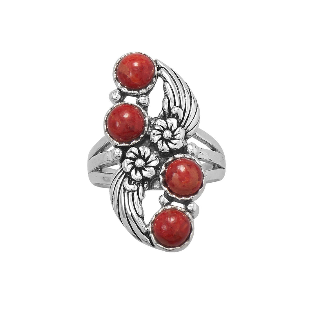 Our stunning oxidized sterling silver ring with dyed red coral and a floral design. The round coral stones measure 5.5mm in diameter, adding a touch of elegance to this unique piece. The total design measures 31mm x 14.5mm, and the band graduates from 2.5mm to 9mm, ensuring a comfortable fit. Available in whole sizes 6-9, it makes a perfect gift for a loved one. Pair it with our other red coral and oxidized sterling silver jewelry pieces for a complete and stylish look.