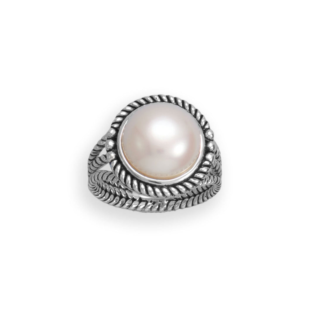 Elevate your style with our exquisite oxidized sterling silver three band rope design ring. Adorned with a stunning jumbo cultured freshwater button pearl, this piece exudes elegance. Available in sizes 6-9, it pairs perfectly with our other pearl and oxidized sterling silver jewelry. Indulge in the beauty and value of .925 sterling silver.