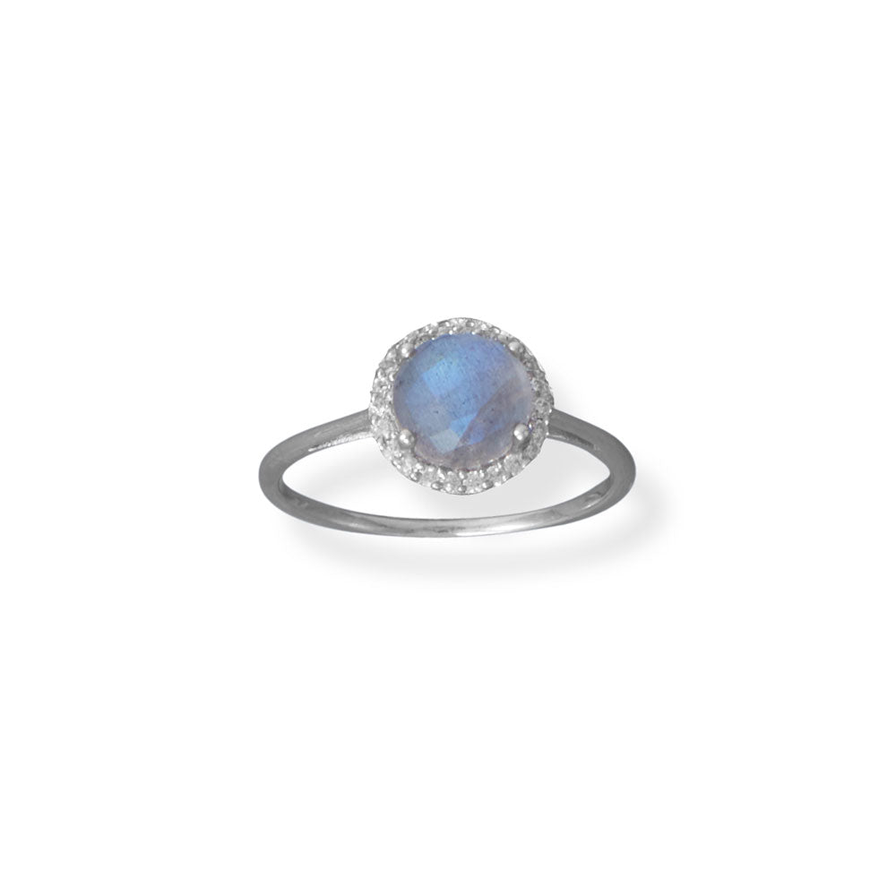 Introducing our exquisite labradorite ring, adorned with a mesmerizing 7mm stone that shimmers and shifts hues with every gaze. Enhanced by a delicate halo of 1.1mm cubic zirconia, this rhodium plated sterling silver masterpiece exudes opulence. Available in sizes 6-9. Impeccable craftsmanship, guaranteed.