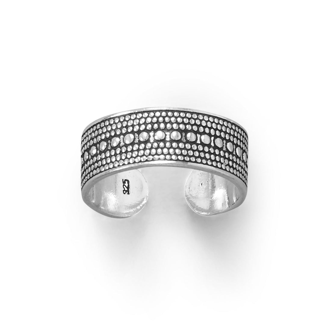 The intricate Bali design of this toe ring is a testament to the rich cultural heritage of the Indonesian island, featuring a unique and intricate pattern that is both elegant and timeless. The oxidized finish of the sterling silver adds a touch of rustic charm to the piece, creating a beautiful contrast that is sure to catch the eye. Measuring 6.3mm in width, this toe ring is the perfect size to fit comfortably on any toe, while the adjustable design ensures a perfect fit for any foot size.