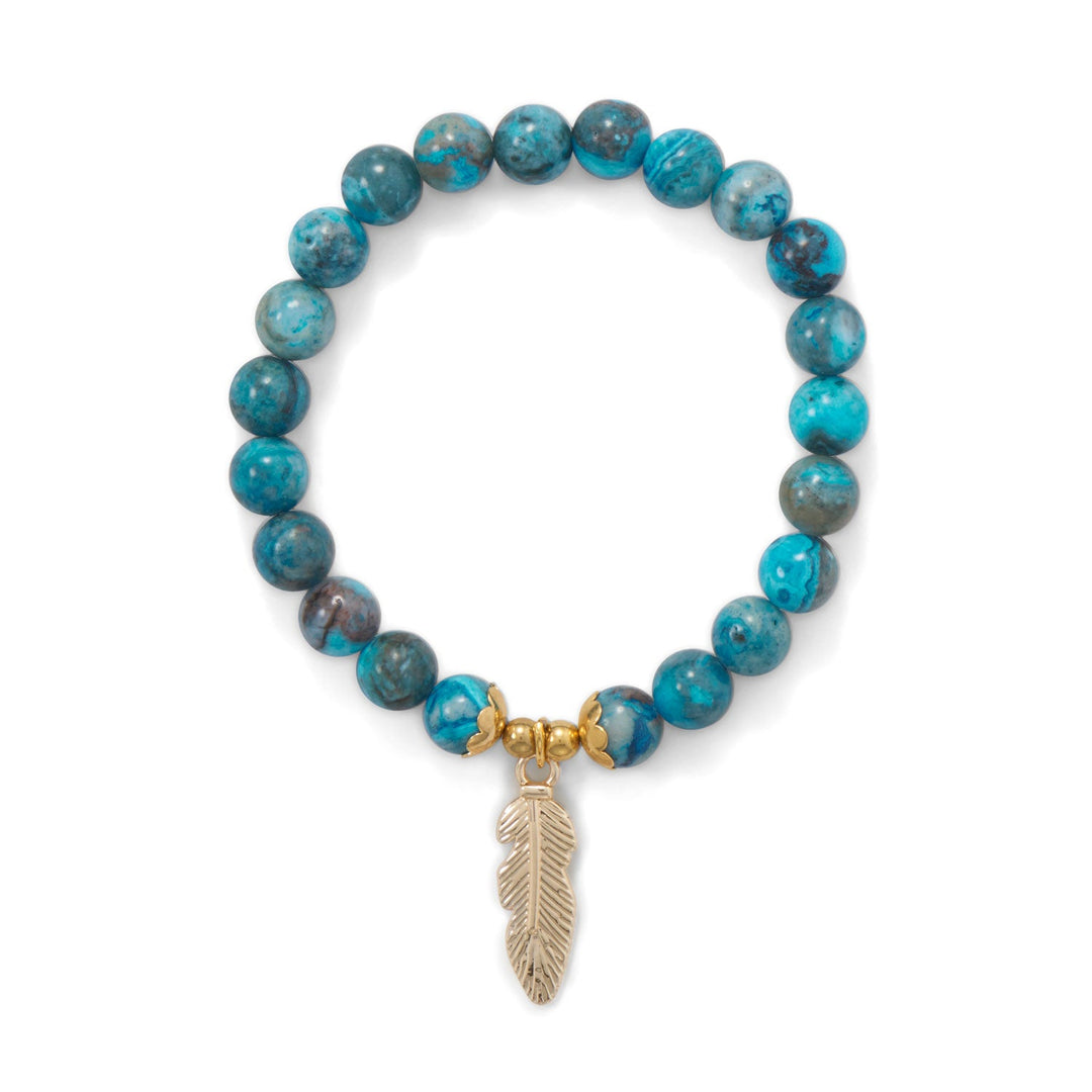 Stretch bracelet with 8mm turquoise dyed agate beads featuring a 25.5mm gold tone fashion base metal feather charm and decorative components. Fashion jewelry contains base metal.